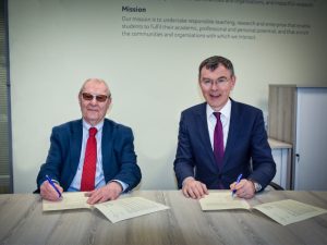 Chair of the Kirklees Climate Commission Professor Peter Roberts OBE signing the Memorandum of Understanding with the University's Deputy Vice-Chancellor Professor Tim Thornton