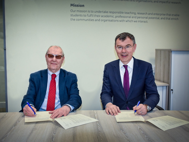 Chair of the Kirklees Climate Commission Professor Peter Roberts OBE signing the Memorandum of Understanding with the University's Deputy Vice-Chancellor Professor Tim Thornton